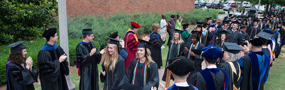 Graduates "walking through" faculty lineup
